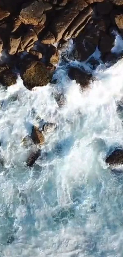 Aerial view of ocean waves crashing against rugged rocks.