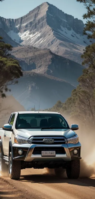 Truck on a dusty trail with mountains in the background.