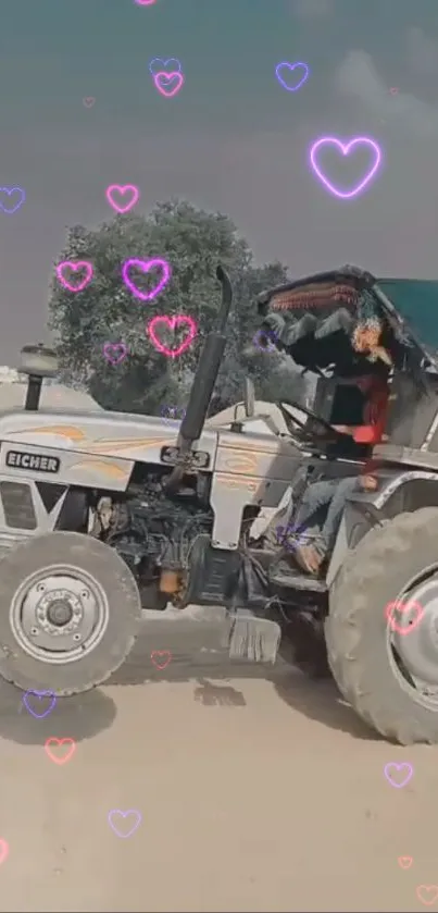 A tractor in a rural setting with pink heart overlays.