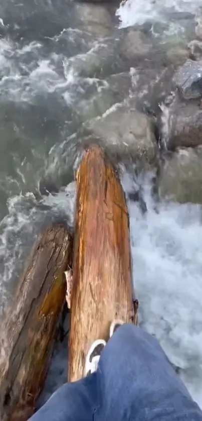 Foot balancing on a log in a rushing river.