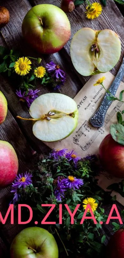 Apples and blossoms on rustic wood with a knife.