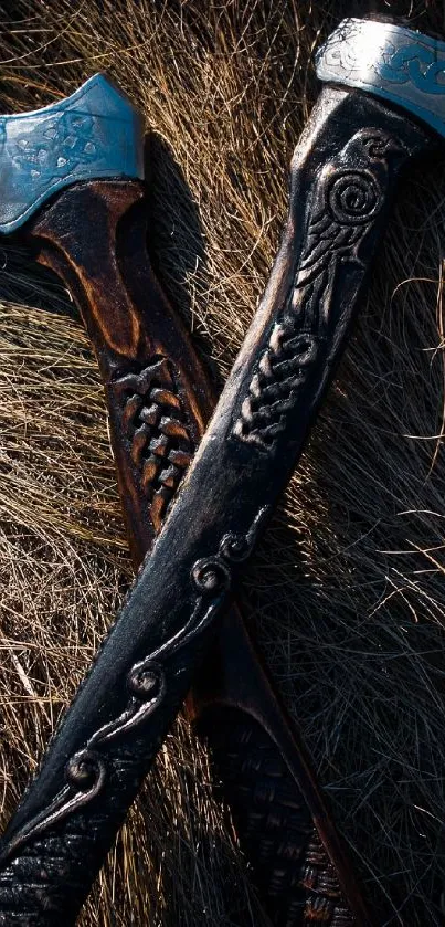 Intricately designed axes lying on straw background, highlighting rustic charm.