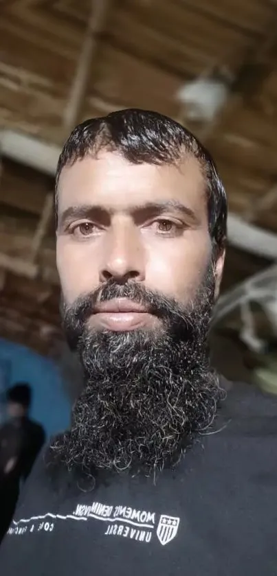 Bearded man in rustic wooden interior setting.