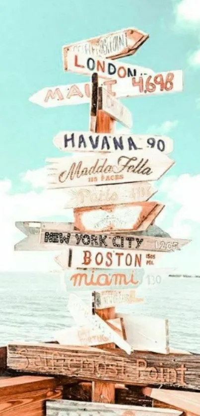 Rustic signpost by the beach with sky blue background.