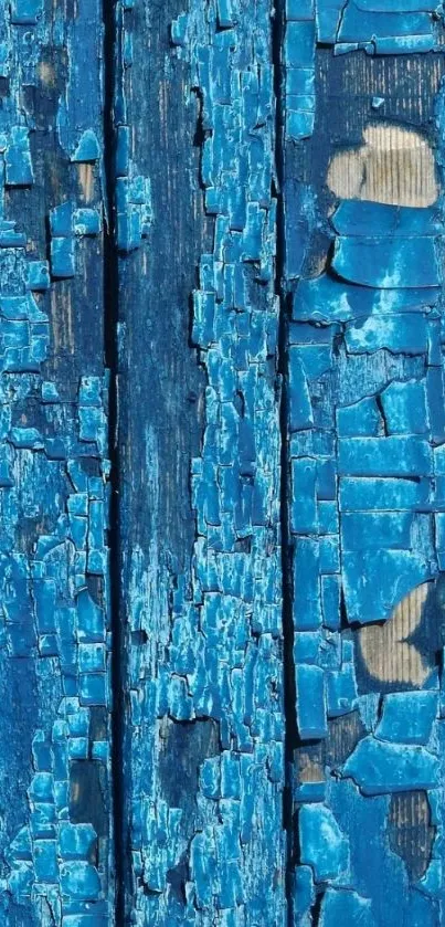 Close-up of rustic blue wood texture with peeling paint on a vertical panel.