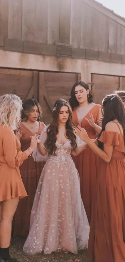 A bridal party in elegant rust dresses gathered outdoors.