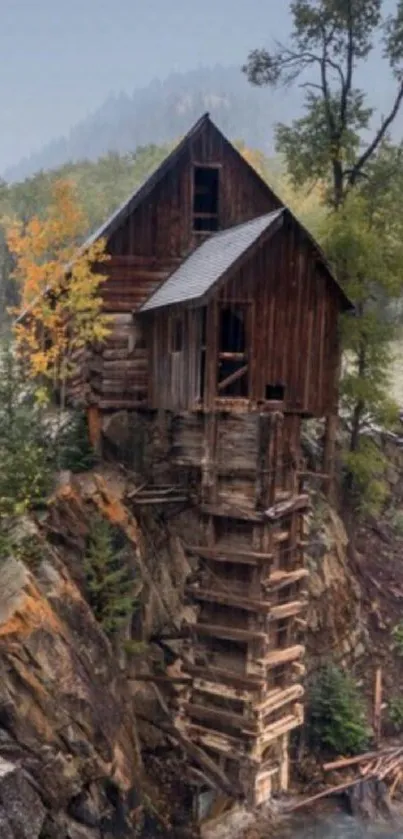 Rustic cabin on rocky cliffs amidst misty mountains.