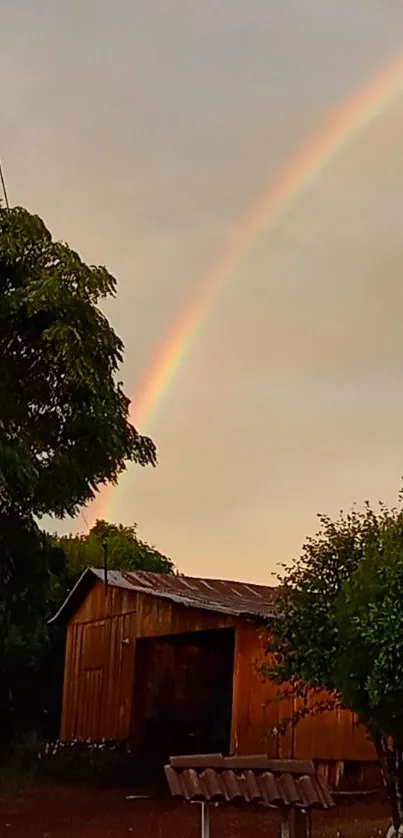 Rustic cabin with a vibrant rainbow in a serene and lush evening landscape.