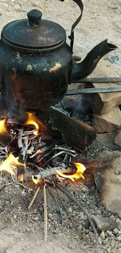 Campfire heating a rustic kettle with vibrant flames outdoors.