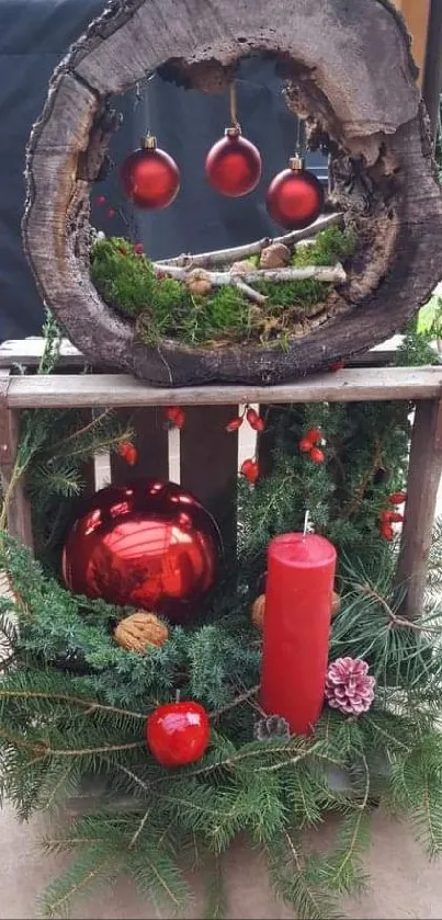 Rustic Christmas decor with red ornaments and pine branches in wooden setup.