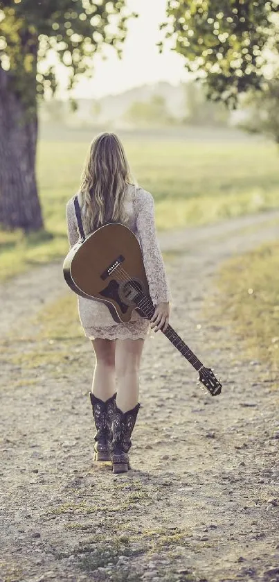 Woman walking with guitar on a country path.