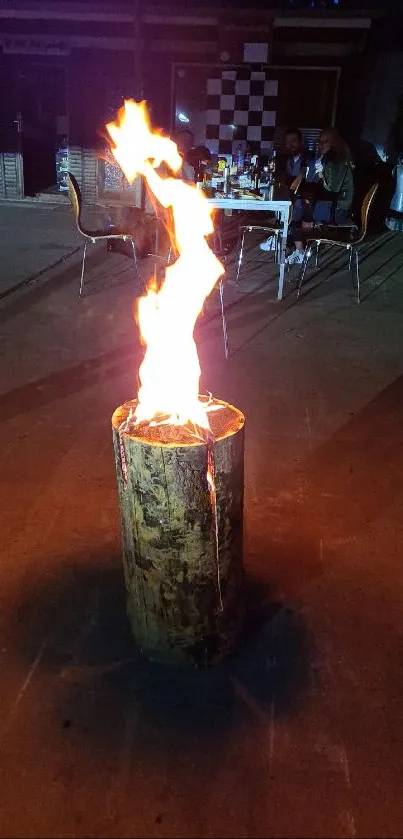 Vivid campfire on a wooden log with a serene evening backdrop.