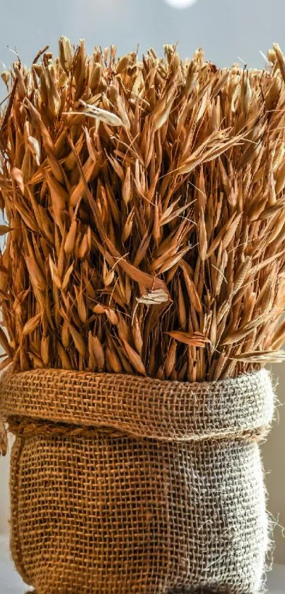 Rustic burlap-wrapped dried wheat bouquet setting.