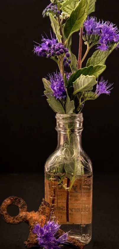 Purple flowers in a vintage glass bottle with a rustic key.