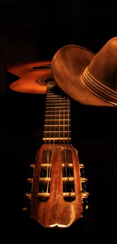 Guitar with cowboy hat in soft dark brown tones.