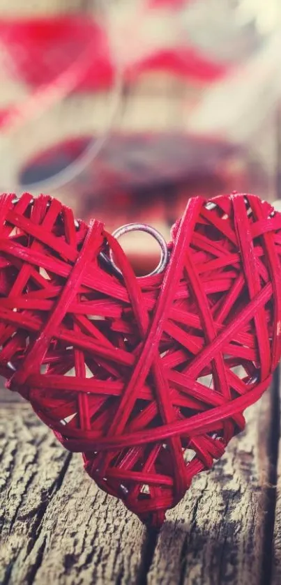 Woven red heart on rustic wood background.