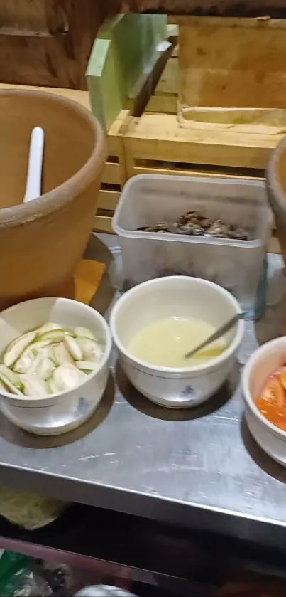 Rustic kitchen setup with bowls and ingredients on a table.