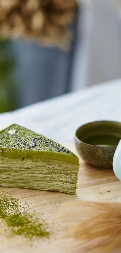 Rustic matcha crepe cake on a wooden table with tea accessories.