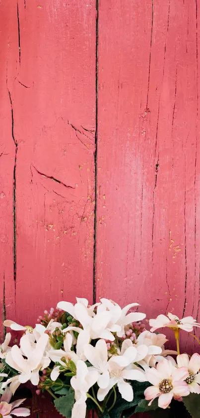 Rustic pink wooden wall with white flowers at the bottom.