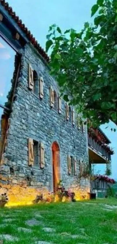 Rustic stone house with greenery and clear sky background.