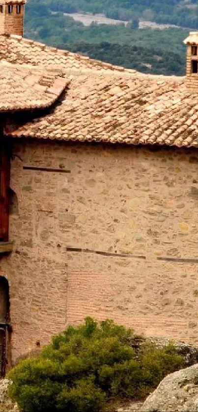 Rustic stone house with chimney and natural backdrop in warm tones.