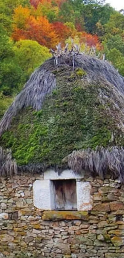 Rustic stone hut surrounded by vibrant autumn foliage.