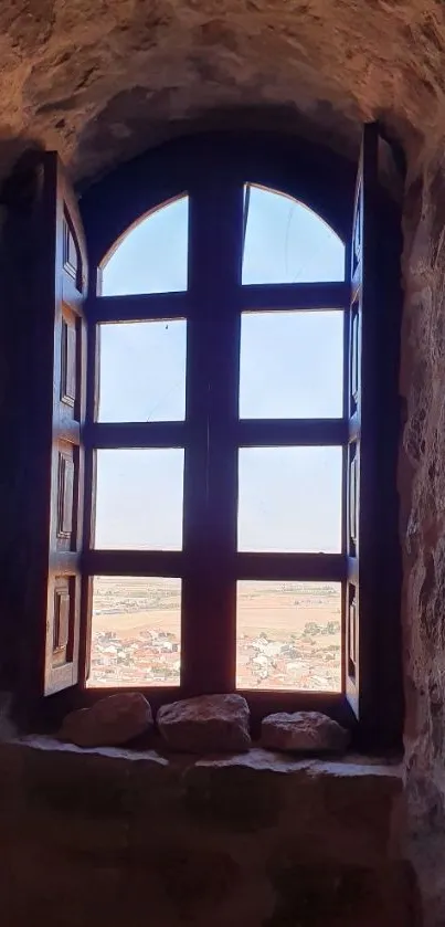 Historic stone window framing a serene outdoor view.