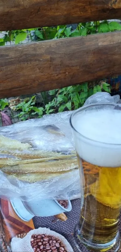 Rustic table with beer and fish on a wooden surface.