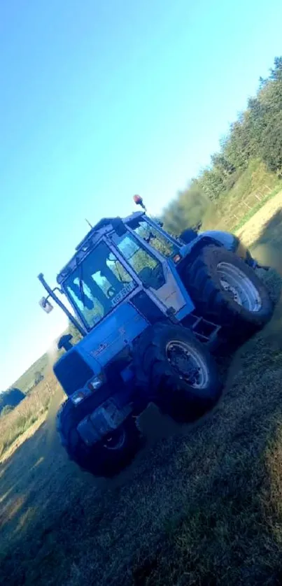 Tractor in a grassy field under a blue sky.