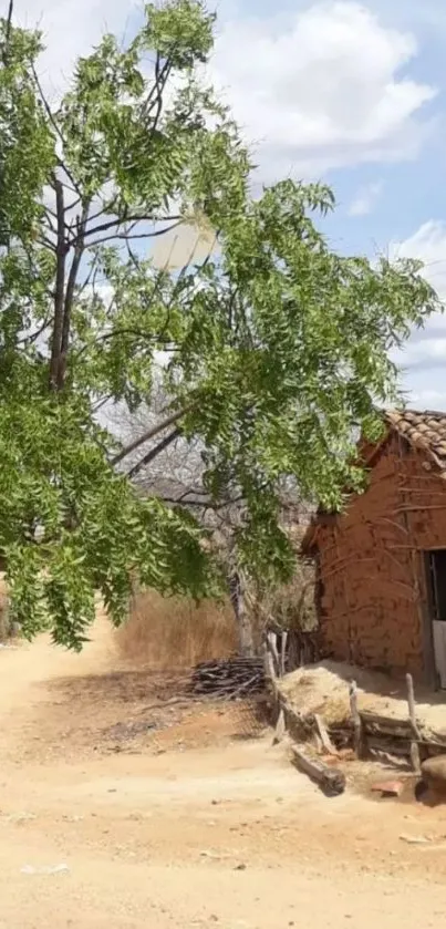 Rustic village scene with a cottage, tree, and blue sky.