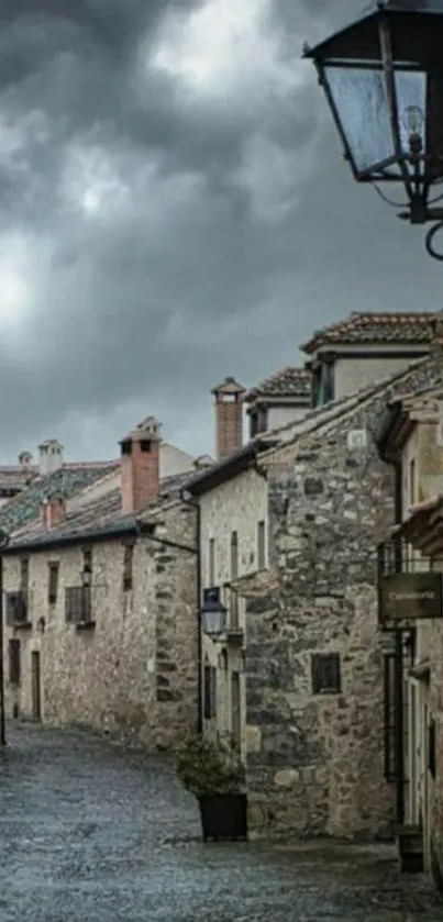 Rustic stone village street under cloudy skies.