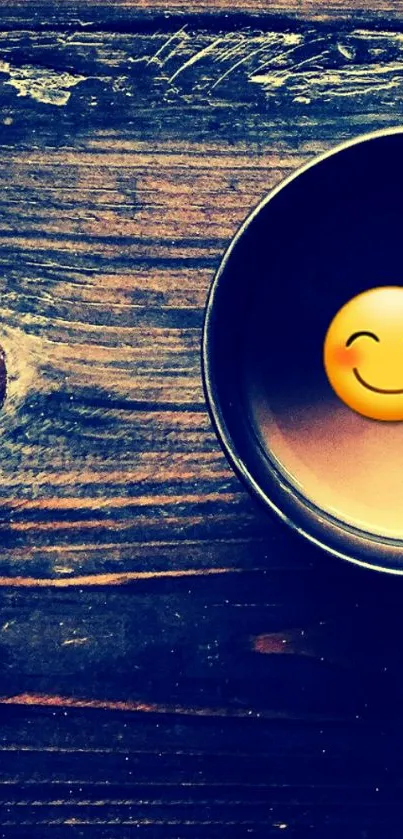 Coffee cup with emoji on wooden table background.