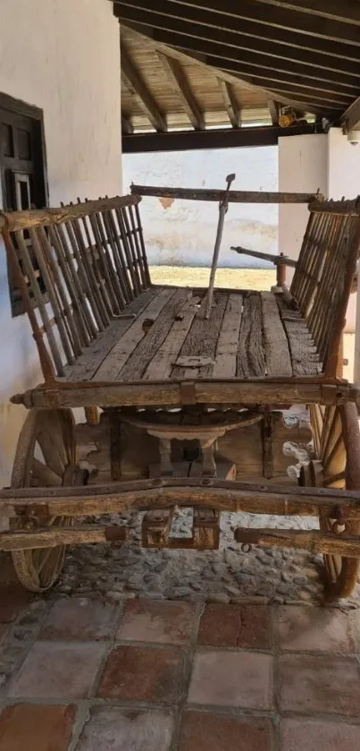 Rustic wooden wagon in a sunny courtyard.