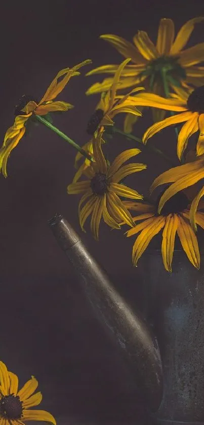 Vintage watering can with yellow flowers in moody lighting.