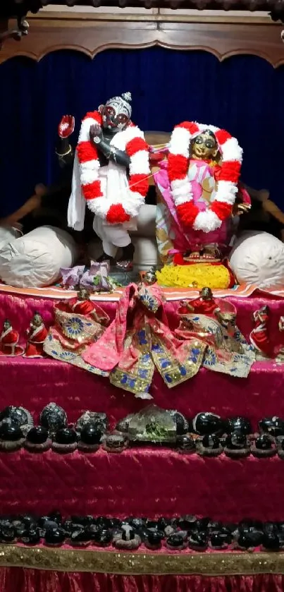 Sacred altar with red decor and sculptures for mobile wallpaper.