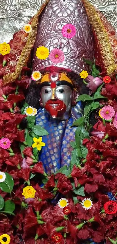 Sacred idol adorned with red flowers.