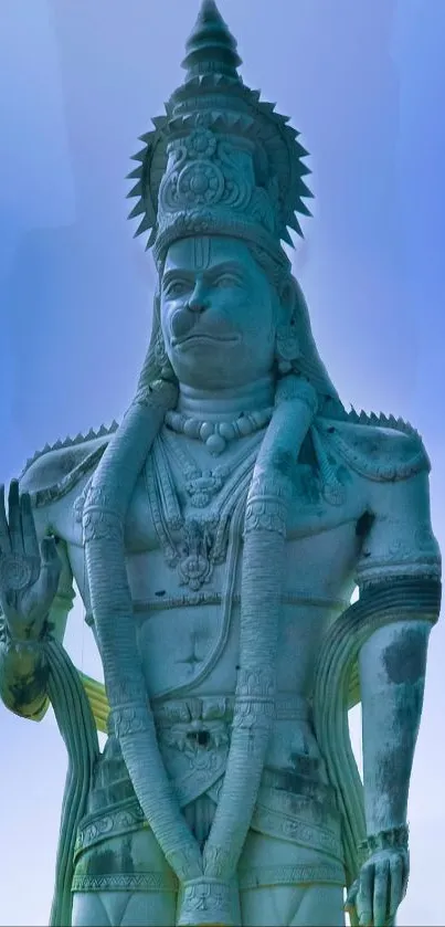 Statue of Hanuman with sky background in serene tones, perfect for mobile wallpaper.