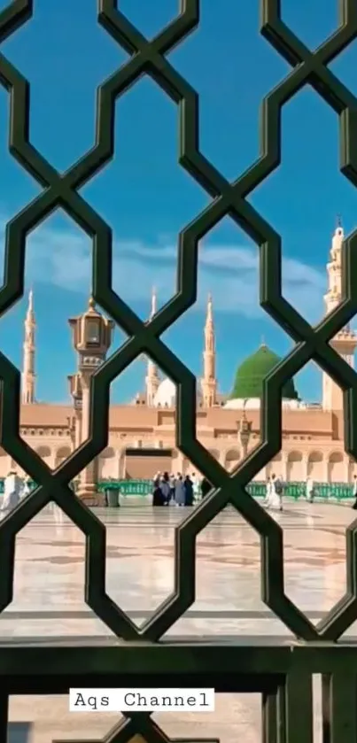 Sacred mosque view framed by a geometric lattice under a vibrant blue sky.