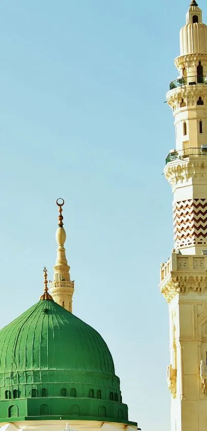 Scenic view of a mosque with a green dome and minarets against a blue sky.