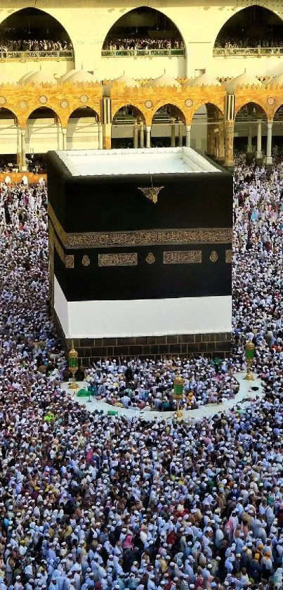 Aerial view of the Kaaba during Hajj with thousands of worshippers surrounding it.