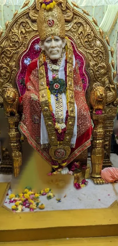 Golden Sai Baba statue with flowers and intricate decor, perfect for wallpaper.