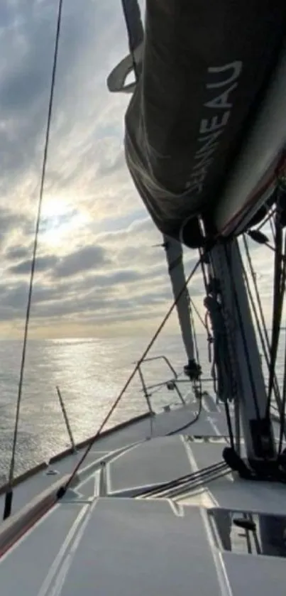 Sailboat on open sea with cloudy sky.