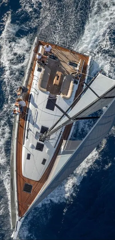 Aerial view of a yacht sailing on a vibrant blue ocean, capturing an adventurous sea journey.