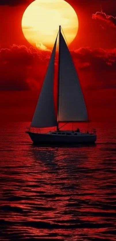 Sailing boat silhouetted against a red sunset on the ocean.