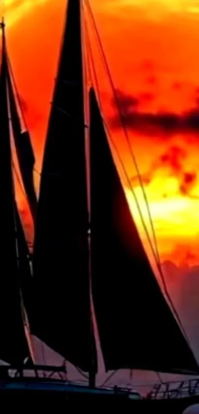 Silhouetted sailboat against fiery sunset sky.