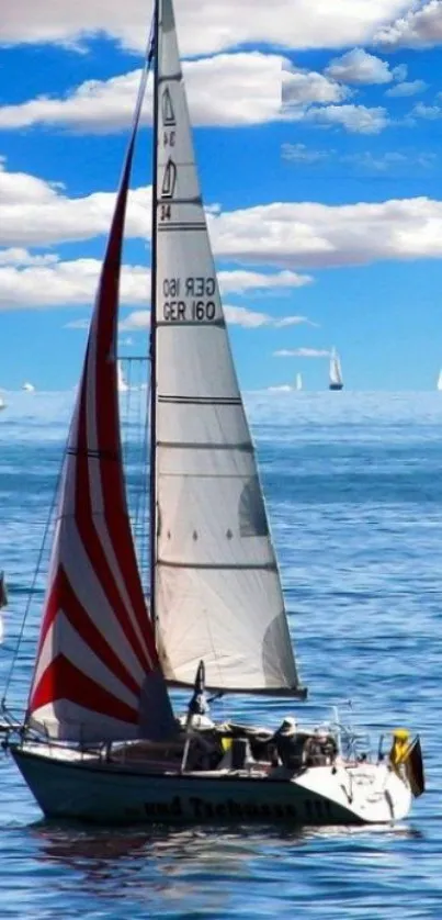 Sailboats on a bright blue sea under a clear sky.