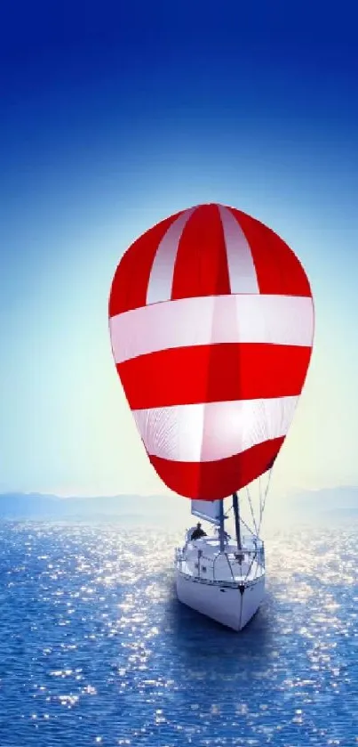 Sailboat wallpaper with blue sky and ocean, striped red and white sail.