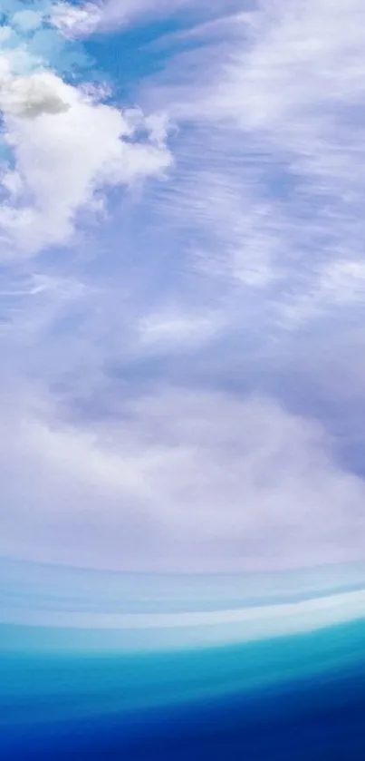 Sailboat gliding on bright blue ocean under a vivid cloudy sky.