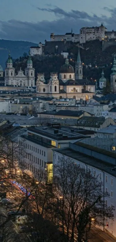 Salzburg city at dusk with castle view and illuminated streets.