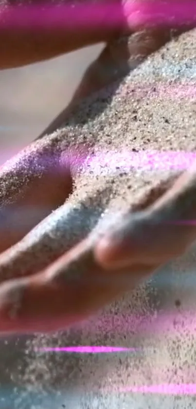 Hand with sand and neon pink streaks in a dynamic wallpaper design.